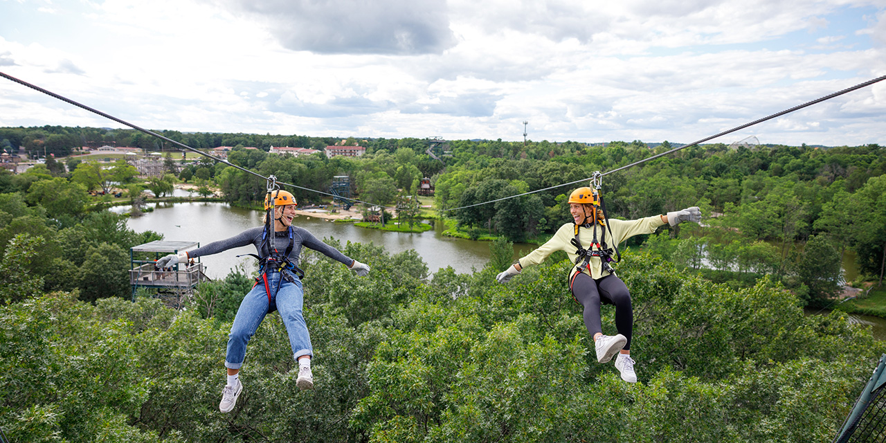 Two women ziplining at Bigoot Ziplines.