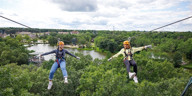 Two women ziplining at Bigoot Ziplines.