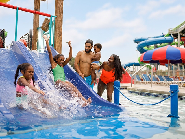 Family playing on waterpark structure at Kalahari Resort Waterpark