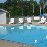Outdoor pool with poolside chairs.