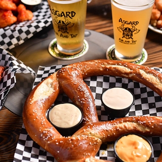 Pub food served including large pretzel and wings.