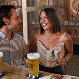 A couple taking a break between throwing axes.