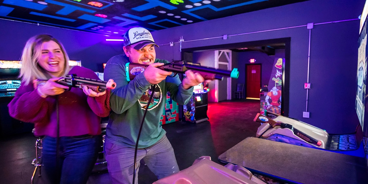 A couple playing a hunting video game.