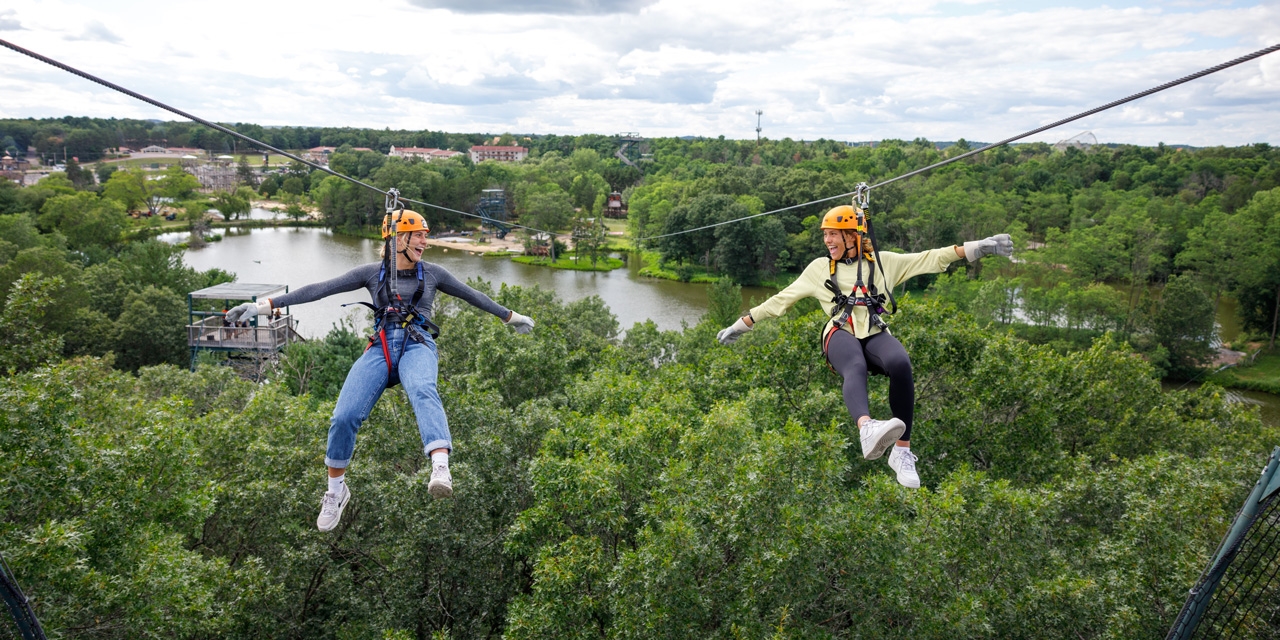 2 girls ziplining.