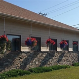 BJ's Restaurant exterior with flowers in hanging pots.