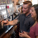 Couple pouring wine at Kilbourn Cork.