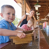 Little boy panning gems.