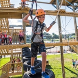 Boy climbing at BigFoot Ropes Course.