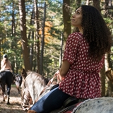 People riding horses through Wisconsin Dells.