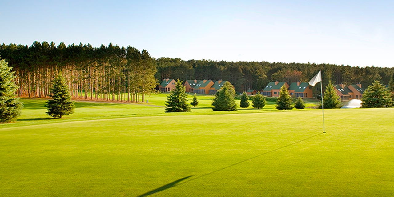 Golf course near a wooded area.