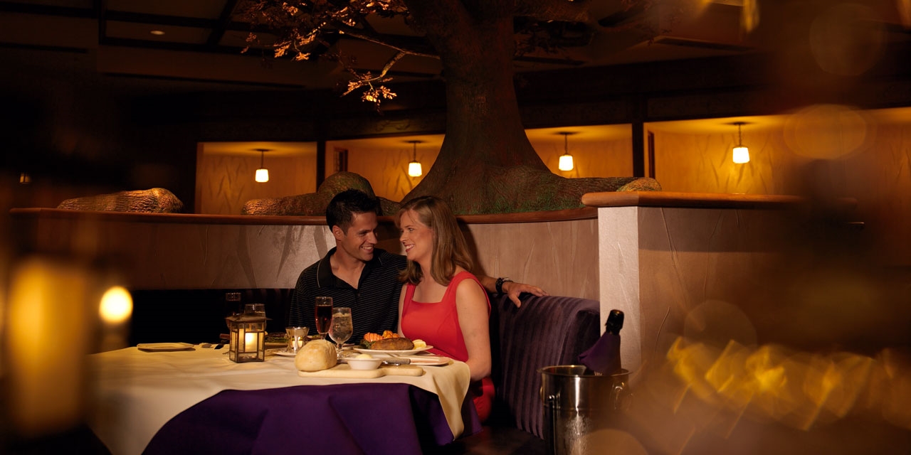 A couple in a romantic dinner setting.