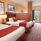 Two-bed bedroom at Chula Vista Resort with sofa, television, desk, and chairs.