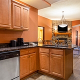 Kitchen space with connected living and dining area.
