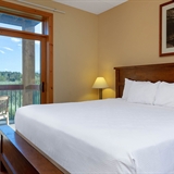 Bed with outdoor patio and outdoor seating.