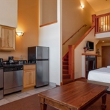 Kitchen/living space next to open bedroom space.