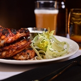Plated chicken wings with greens on the side.