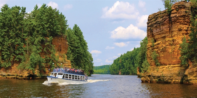 A Dells Boat Tours boat showing off the unique Wisconsin Dells rock formations.