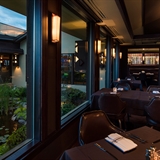 Indoor dining area with a view to the outdoor pond.