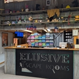 Reception desk with Elusive Escape Rooms logo..