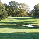A straightaway flanked by trees.