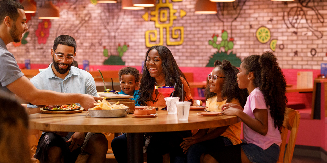 Family dining inside a colorful Mexican restaurant.