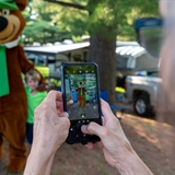 Family taking a photo with Yogi Bear.