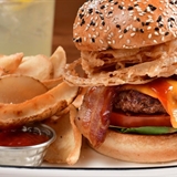 Plated burger with potato chip.