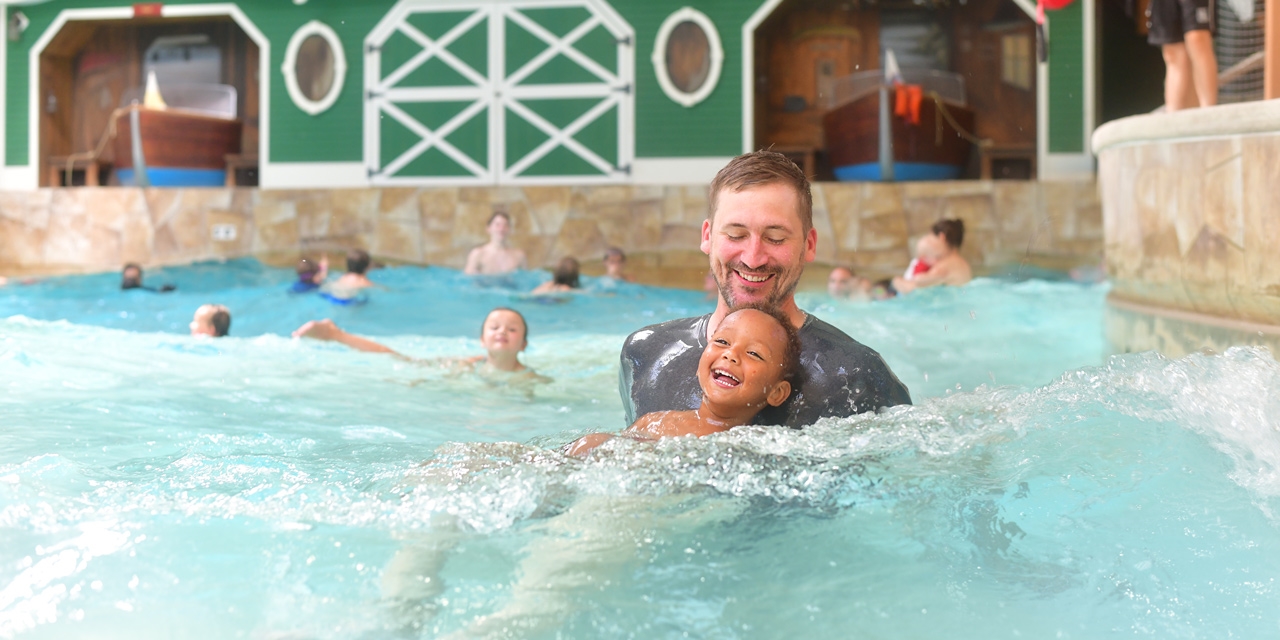 Father and son at Great Wolf wave pool.