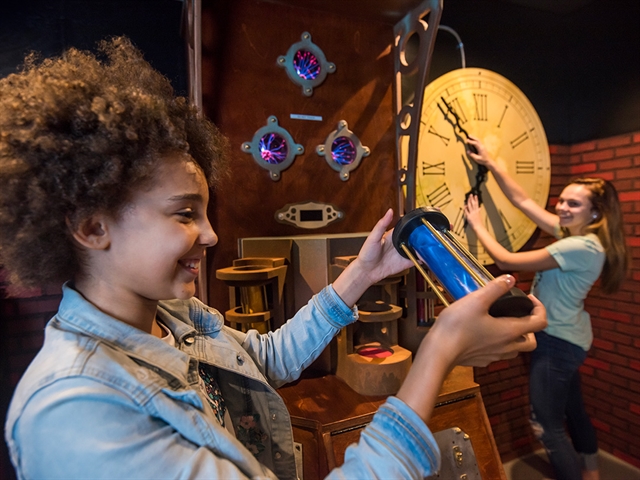 Girls solving problems at Booby Trap Escape Rooms.