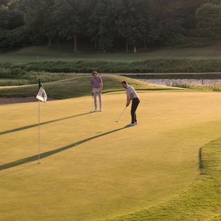 Two people playing golf in Wisconsin Dells.