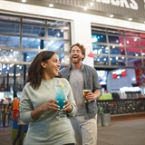 A couple having drinks in the outside dining area at Grateful Shed.