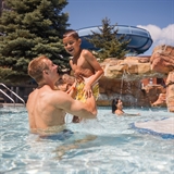Dad and boy having fun at a waterpark.