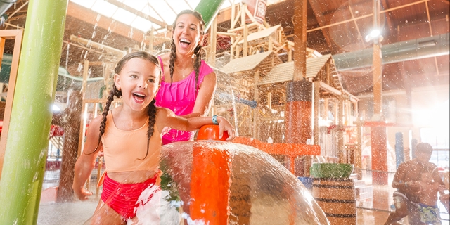 Mom and girl in an indoor waterpark.