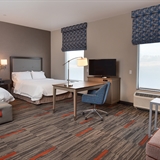 Two bed bedroom with a desk and sofa.