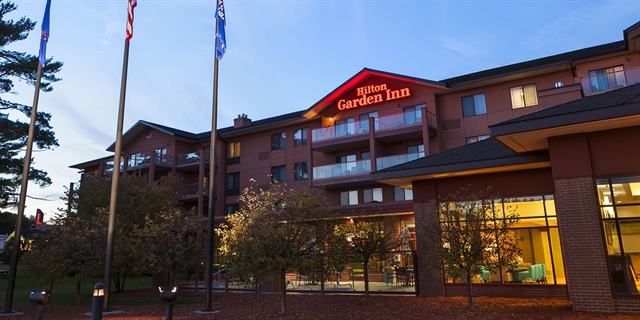 Hilton Garden Inn exterior with trees.