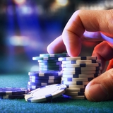 Hand holding poker chips.