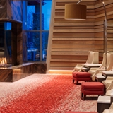 Living space with arm chairs, coffee table, and television.