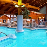 Bedroom with table, chairs, sofa, fireplace, television, and bathtub.