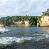 A couple riding around on a jet ski.