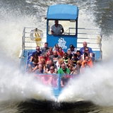 A jet boat splashes through the water in Wisconsin Dells.