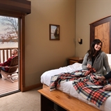 A family relaxing in a bedroom and outdoor patio.