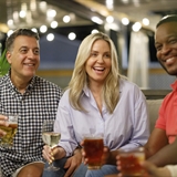 Friends enjoy drinks on the patio at Lake House Grill & Bar