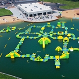 Overview of Land of Natura's lake and buildings.