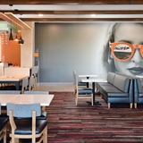 Lobby area with tables and chairs for dining and socializing.