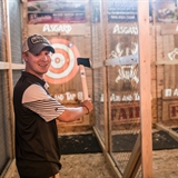 Young man throwing axe.