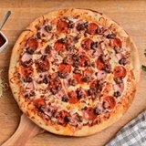 Pizza topped with different meats.