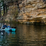 A family observes Wisconsin Dells' unique rock formations.