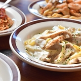 Different pasta options and breadsticks.