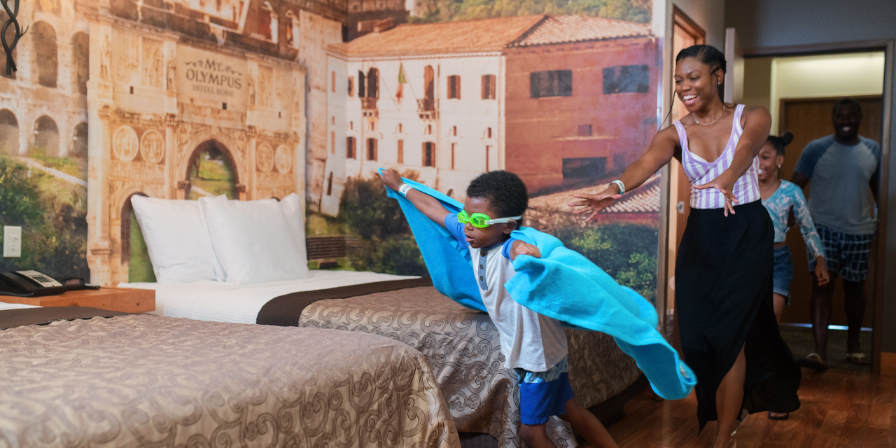 Mom and child playing in a hotel room.
