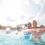 Kids playing in a pool with inner tubes.